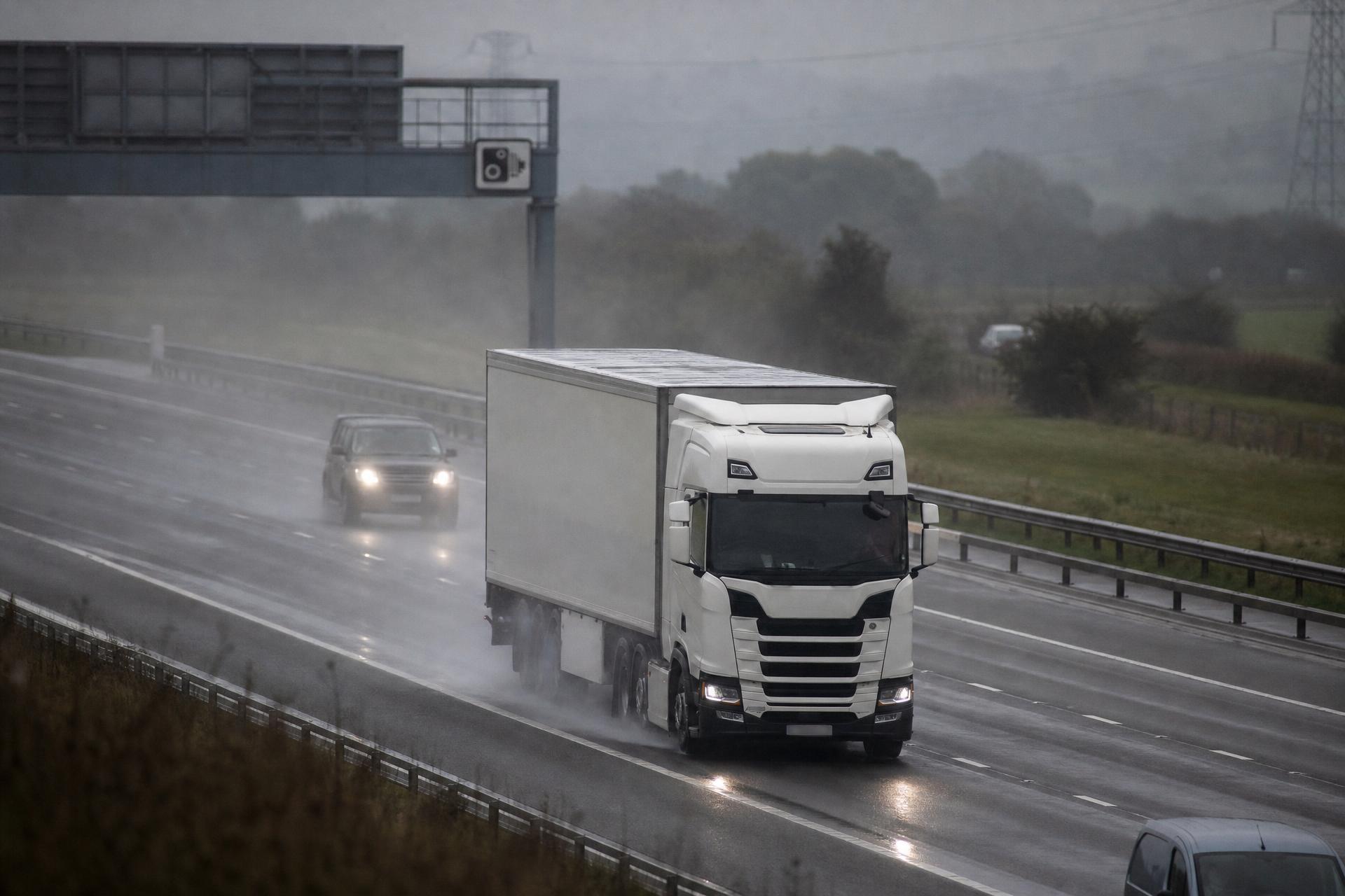 Articulated lorry running a wet British motorway on an overcast morning
