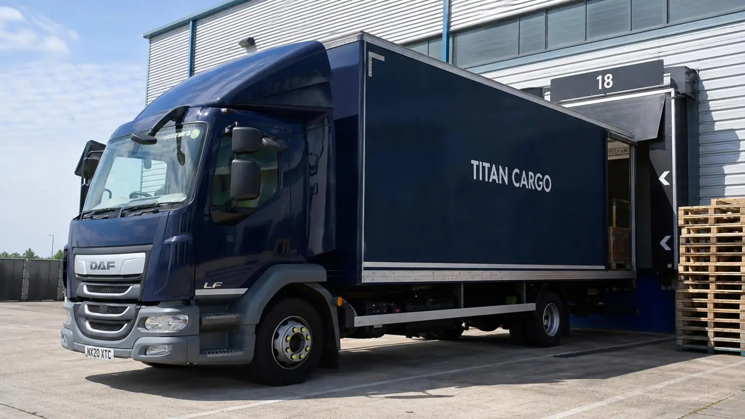 A liveried van loaded for a direct same-day delivery in a UK yard